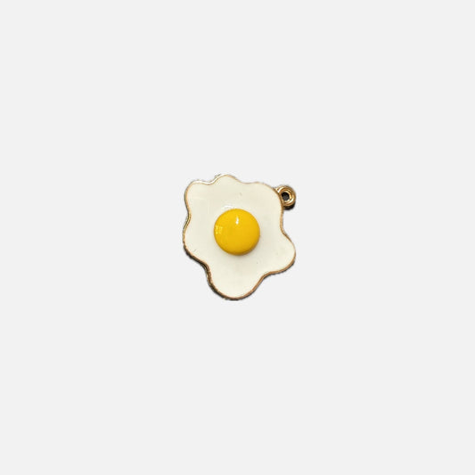 Fried egg-shaped pendant on a white background