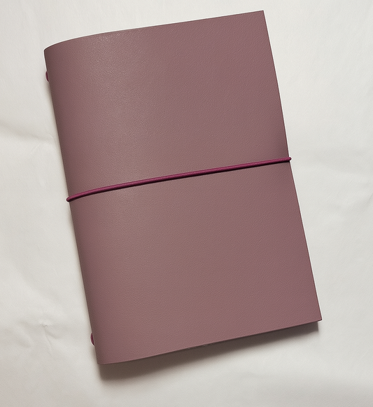 Purple notebook with a strap on a white background
