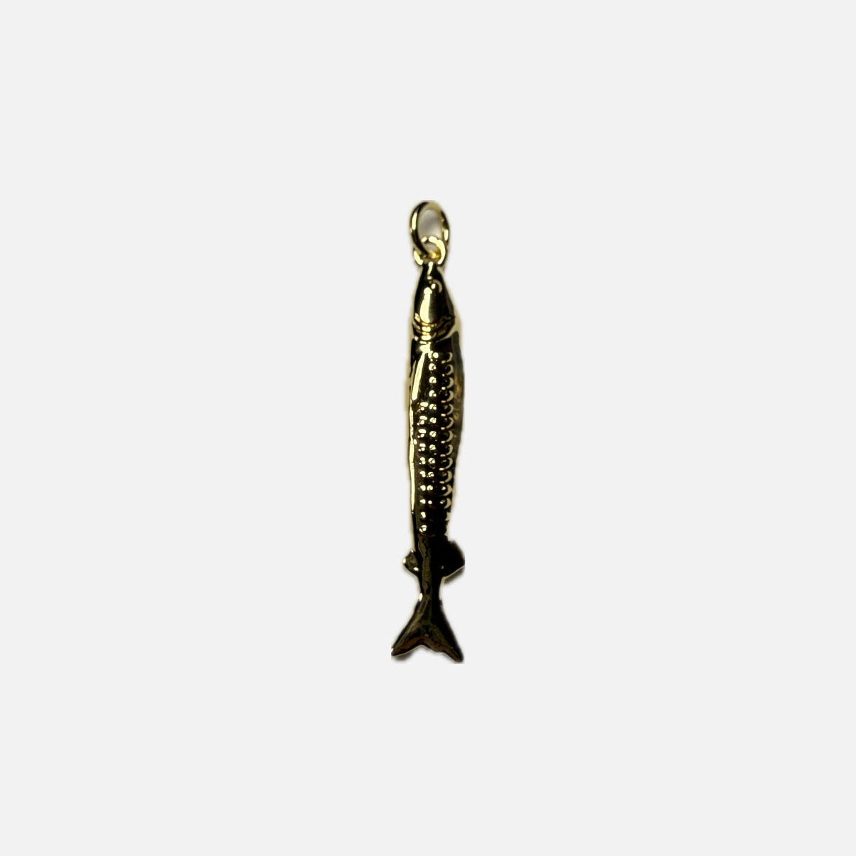 Gold fish-shaped pendant on a white background