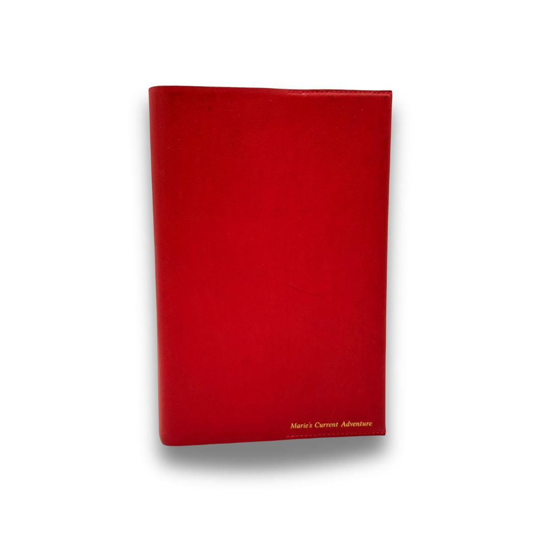 Red book cover with 'Marie's Current Adventure' text on a white background
