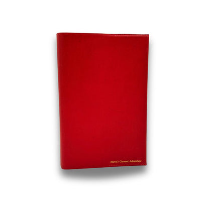 Red book cover with 'Marie's Current Adventure' text on a white background