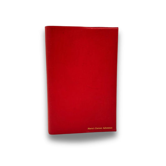Red book cover with 'Marie's Current Adventure' text on a white background