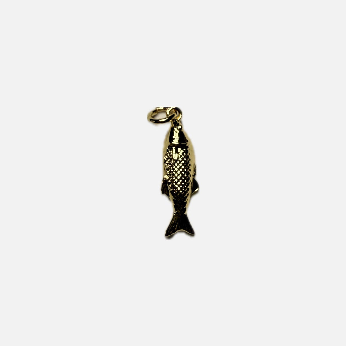 Gold fish-shaped pendant on a white background