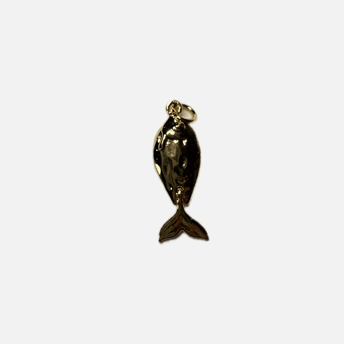 Gold fish-shaped pendant on a white background