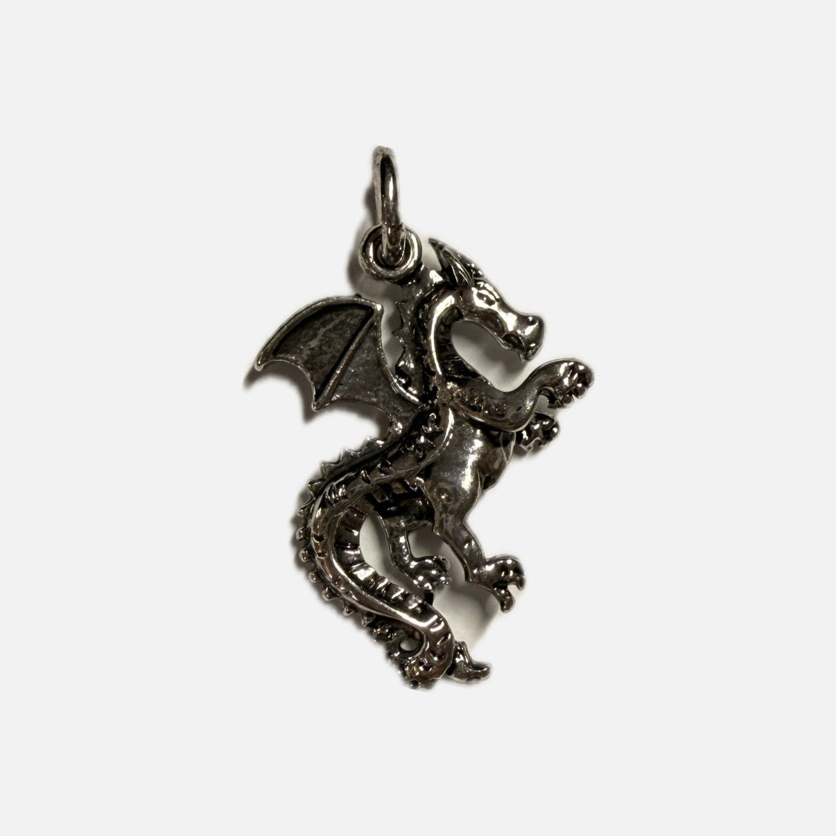 Silver dragon pendant on a white background
