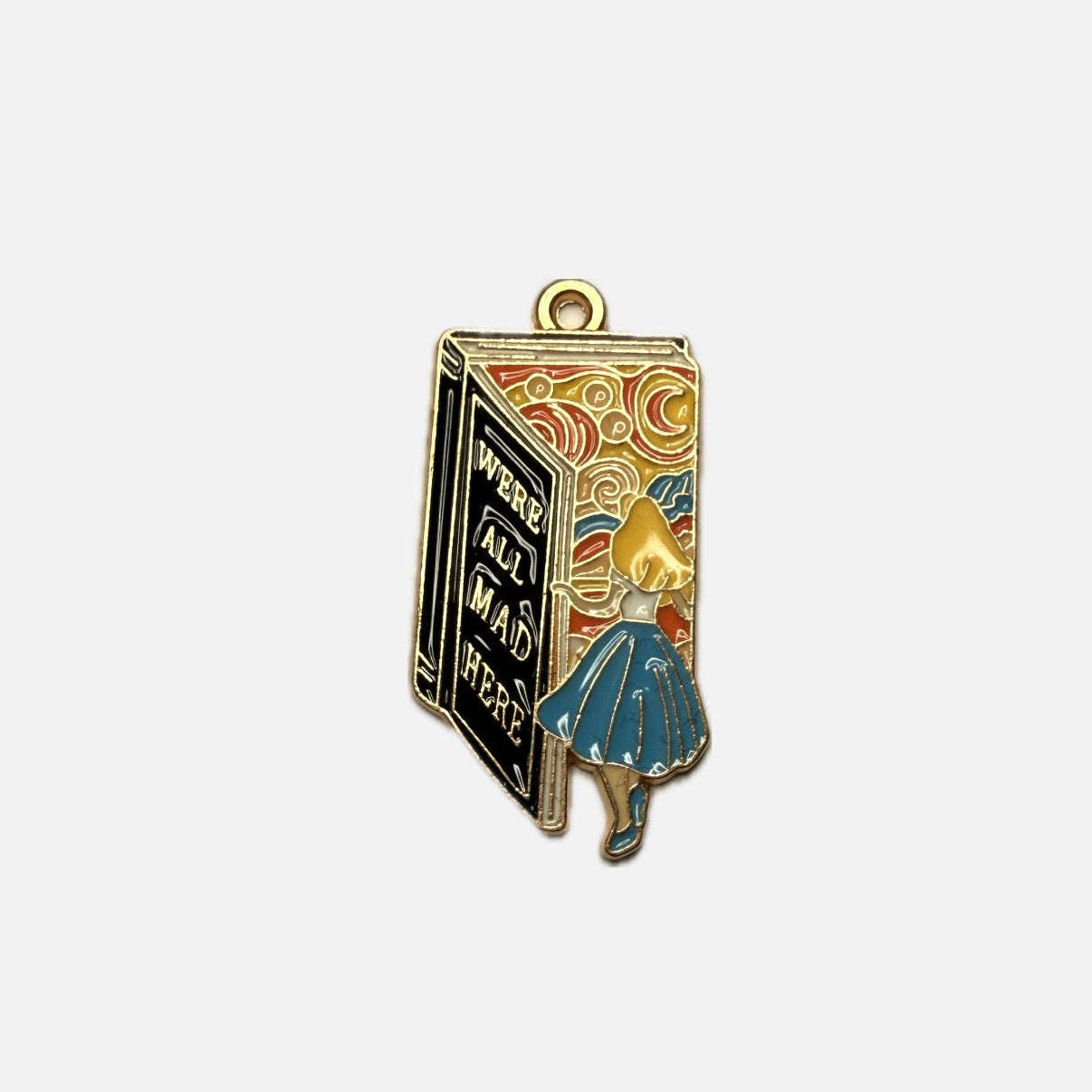 Enamel pendant of a book with Alice in Wonderland on a white background